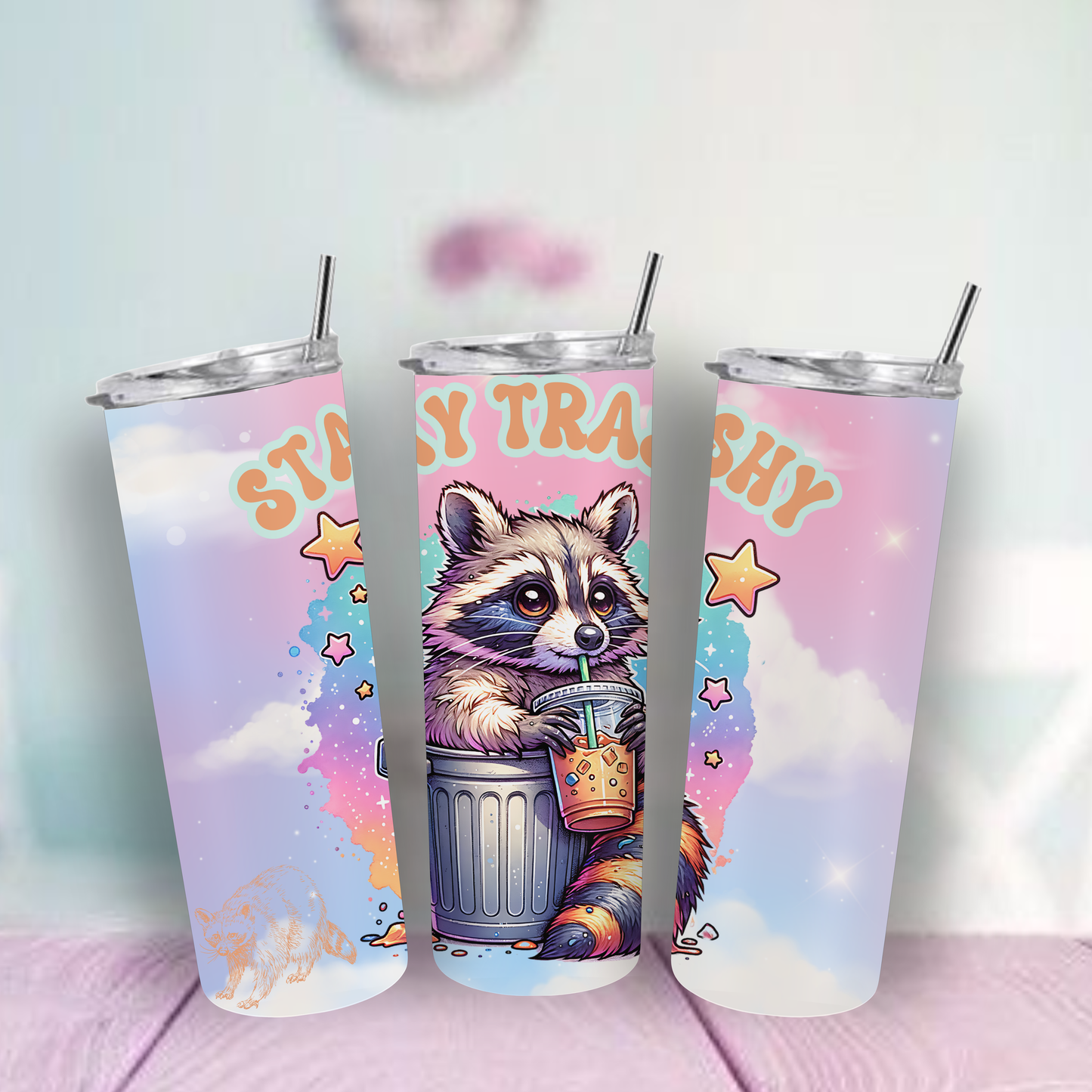 Tumbler with a raccoon design and 'Stay Trashy' text on a pastel background.