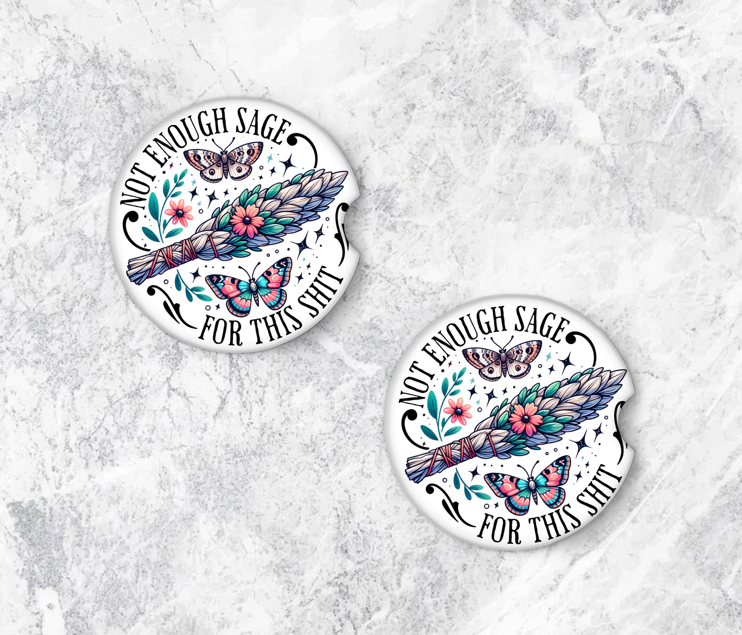 Two circular coasters with floral and butterfly design on a textured surface