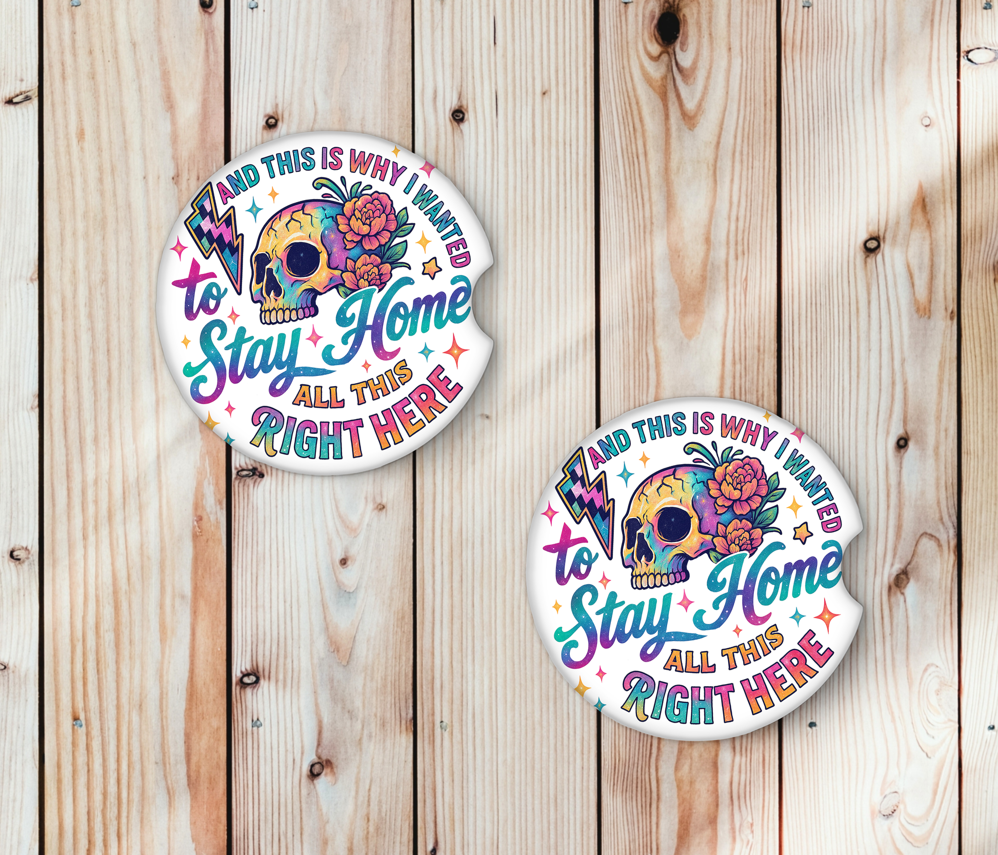 Two Car Coasters with a colorful skull design and text on a wooden background.