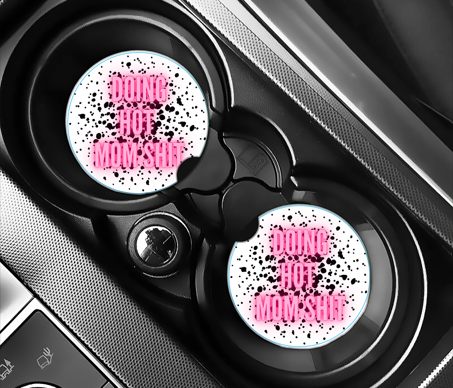 Car cup holder with two pink and white speckled coasters labeled 'Don't Hot Mommy'.