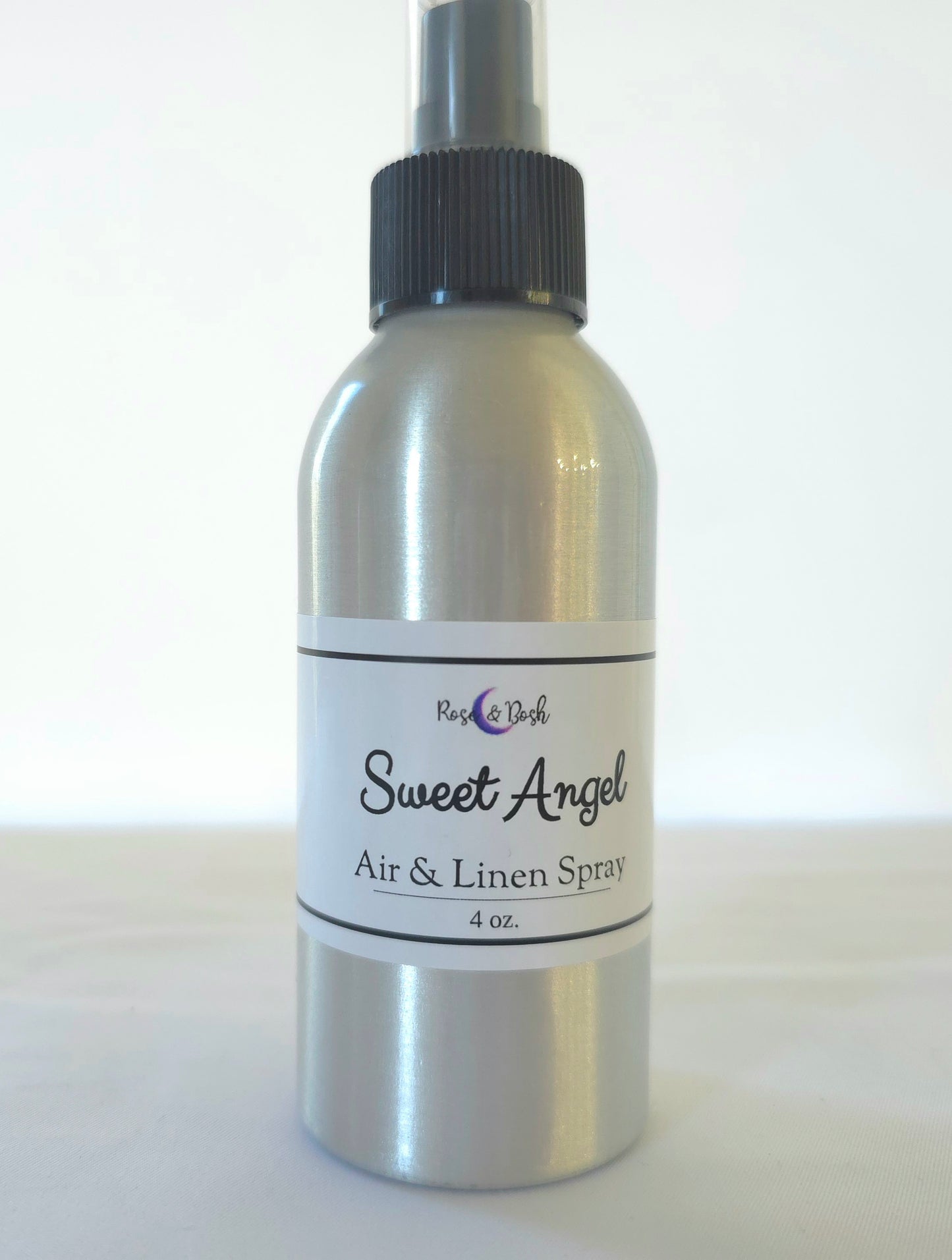 Silver spray bottle labeled 'Sweet Angel' on a white background