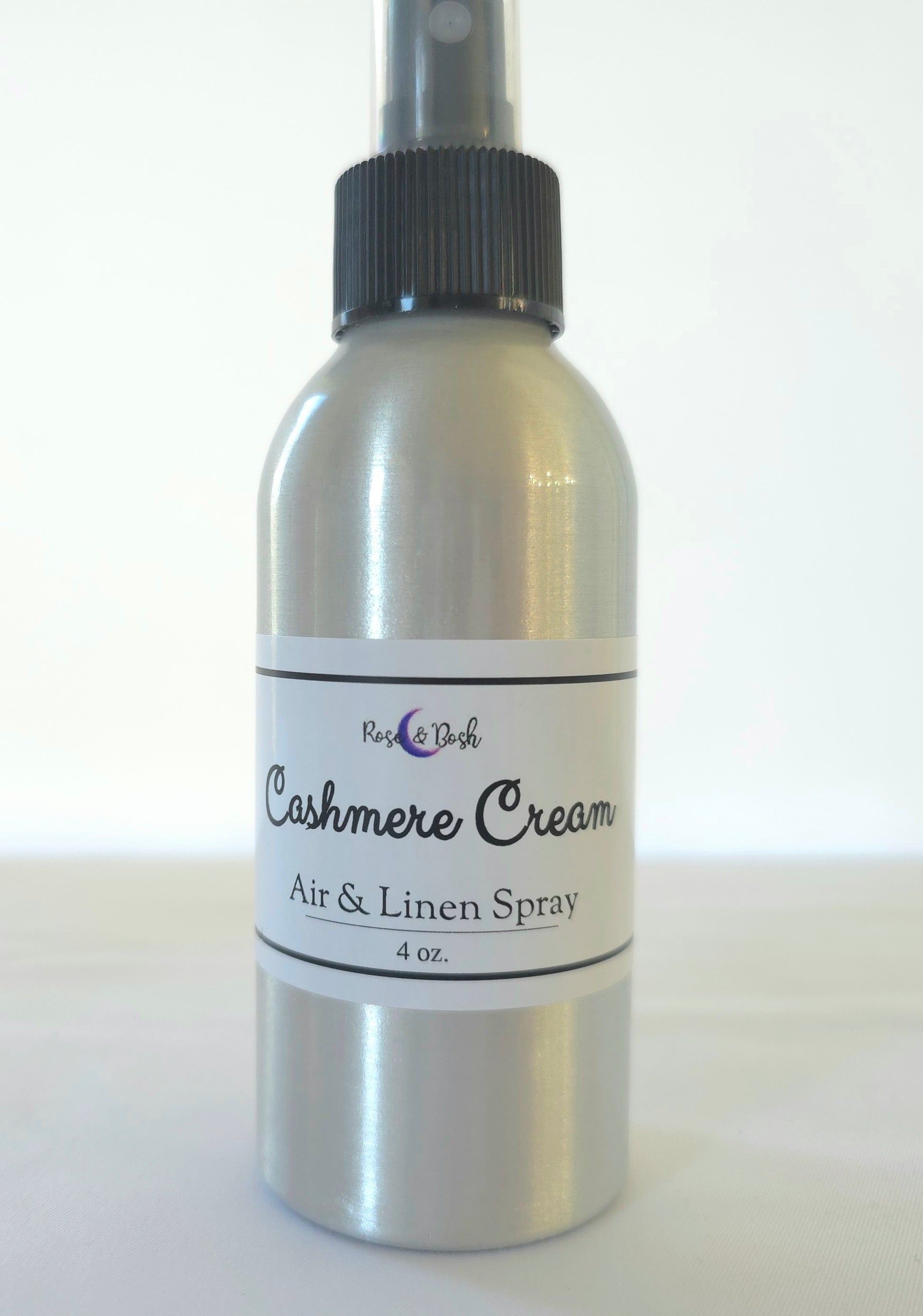 Silver bottle of Cashmere Cream air and linen spray on a white background