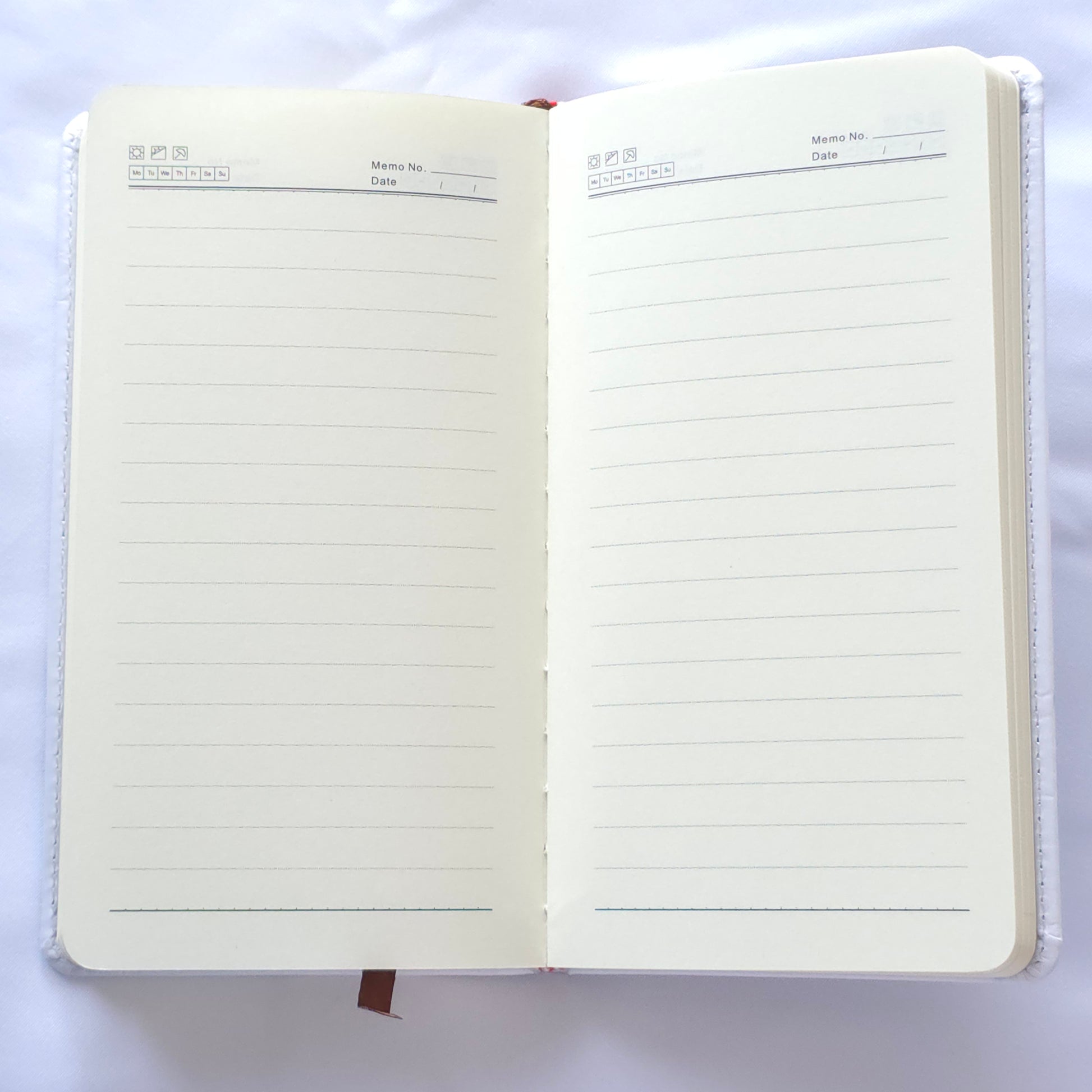 Open notebook with lined pages on a white background