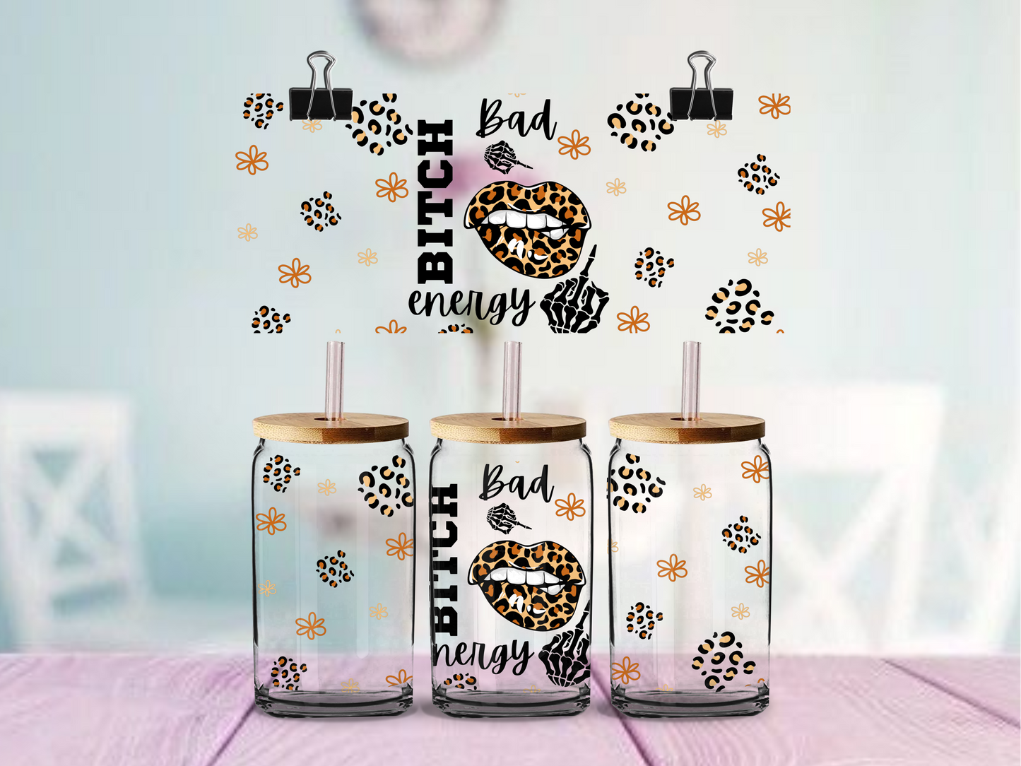 glass tumbler with wooden lids and animal print designs on a light background