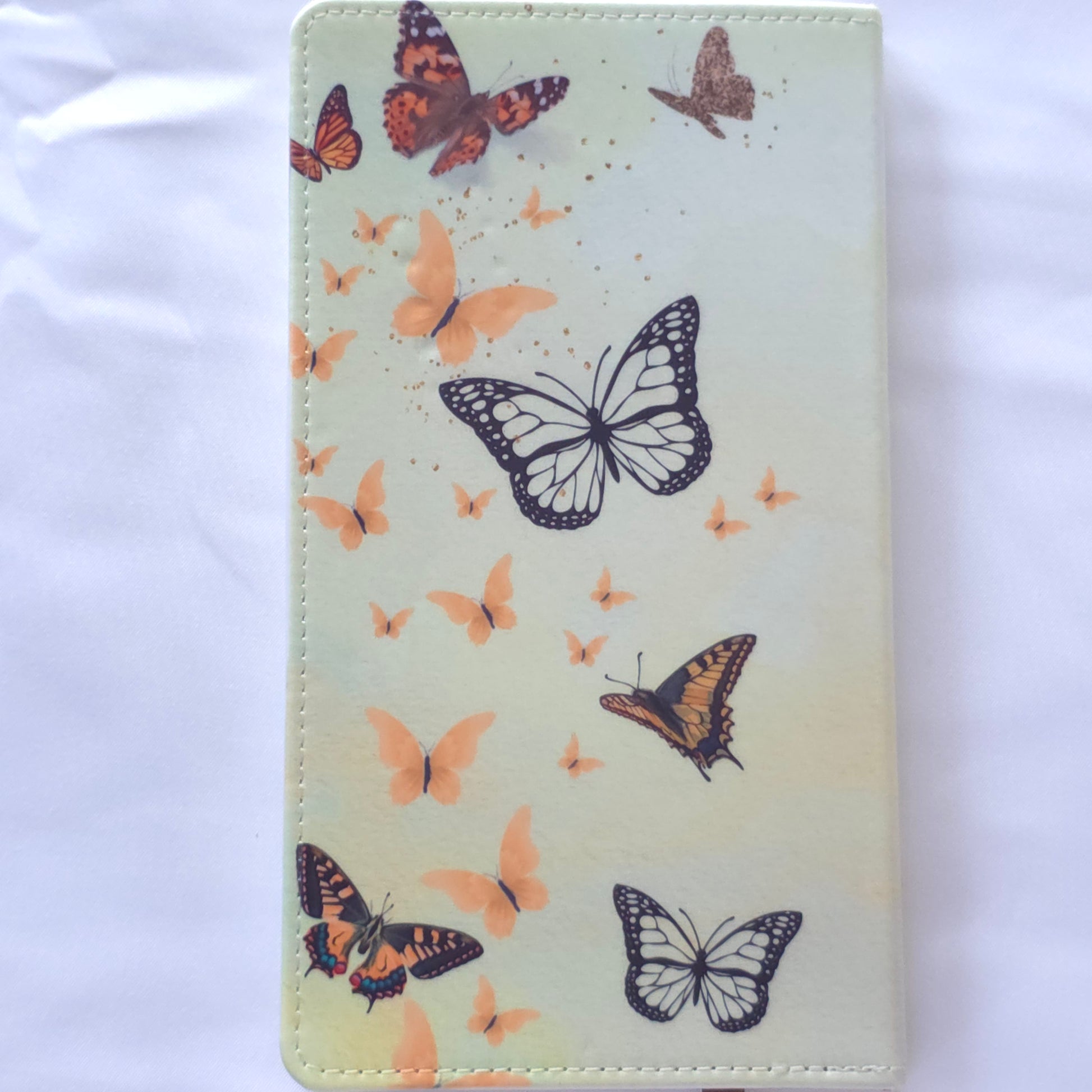 Wallet with butterfly design on a cream background