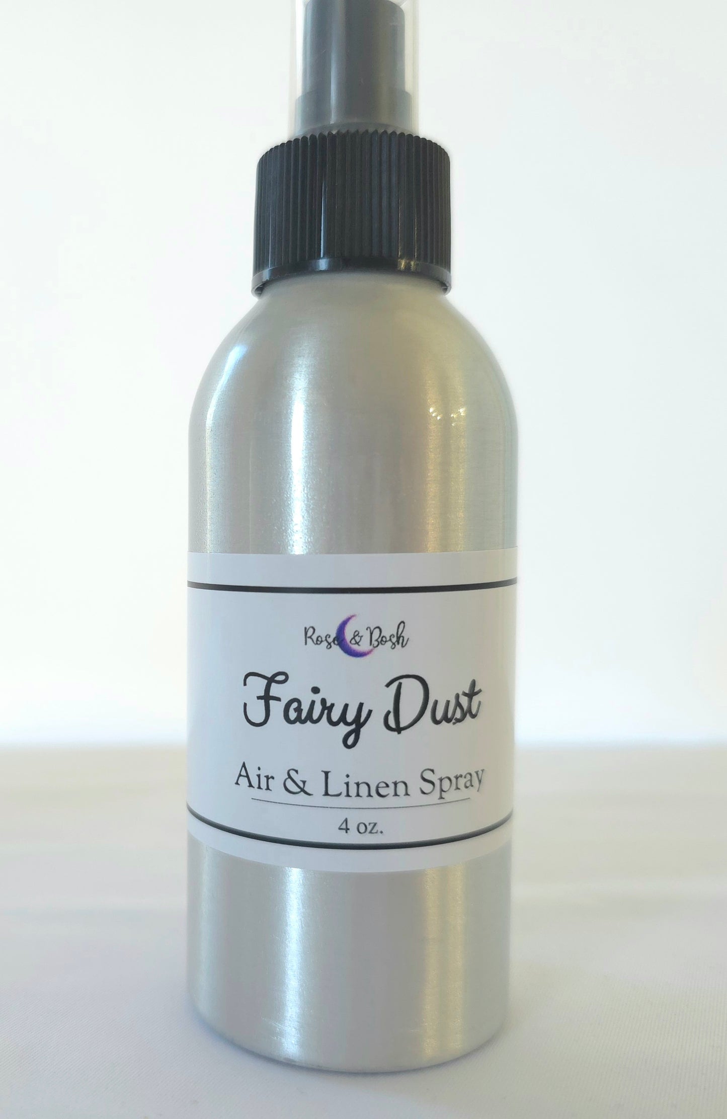 Silver spray bottle labeled 'Fairy Dust Air & Linen Spray' on a white background