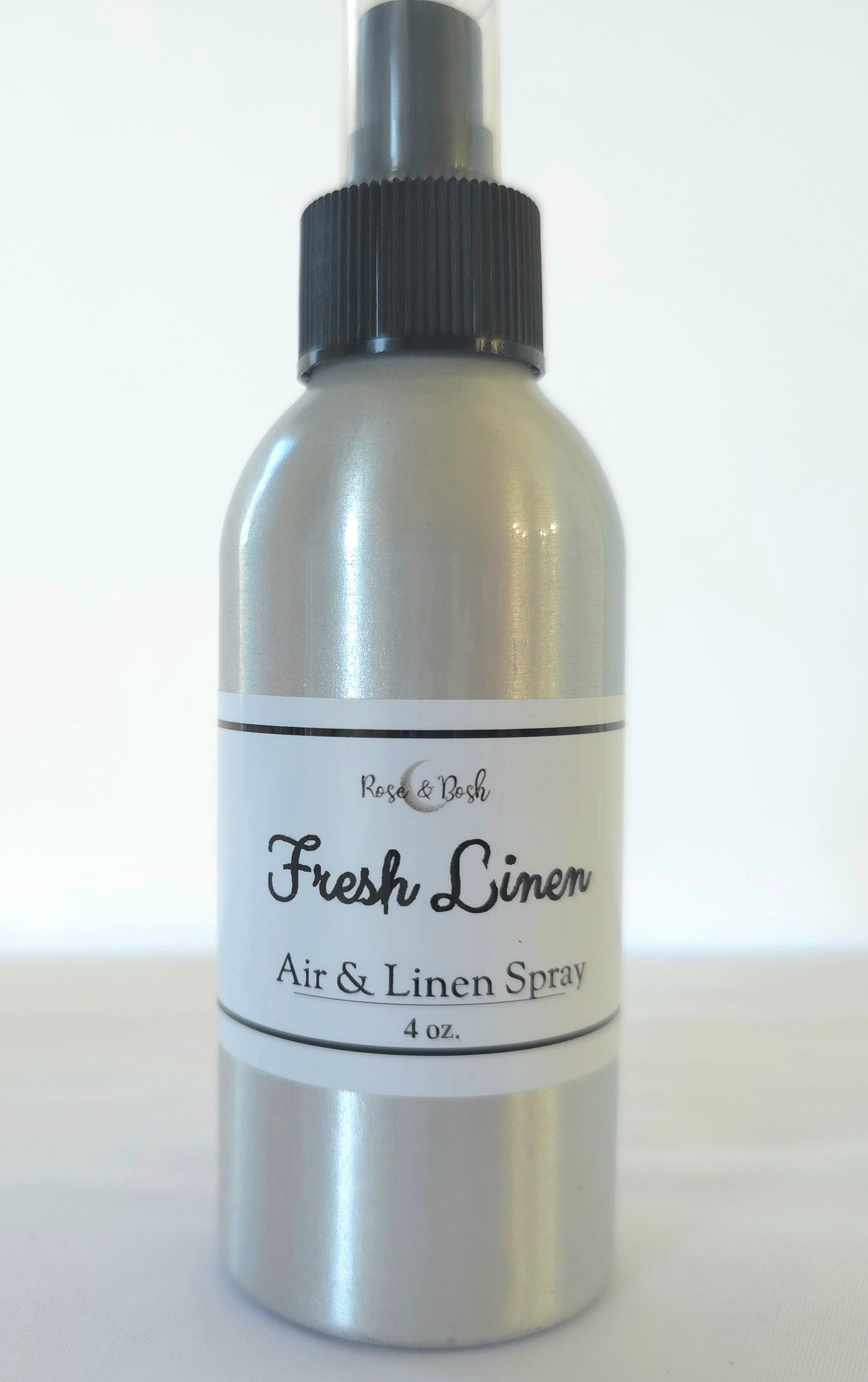 Silver air and linen spray bottle, Fresh Linen Scent, with black cap on a white background
