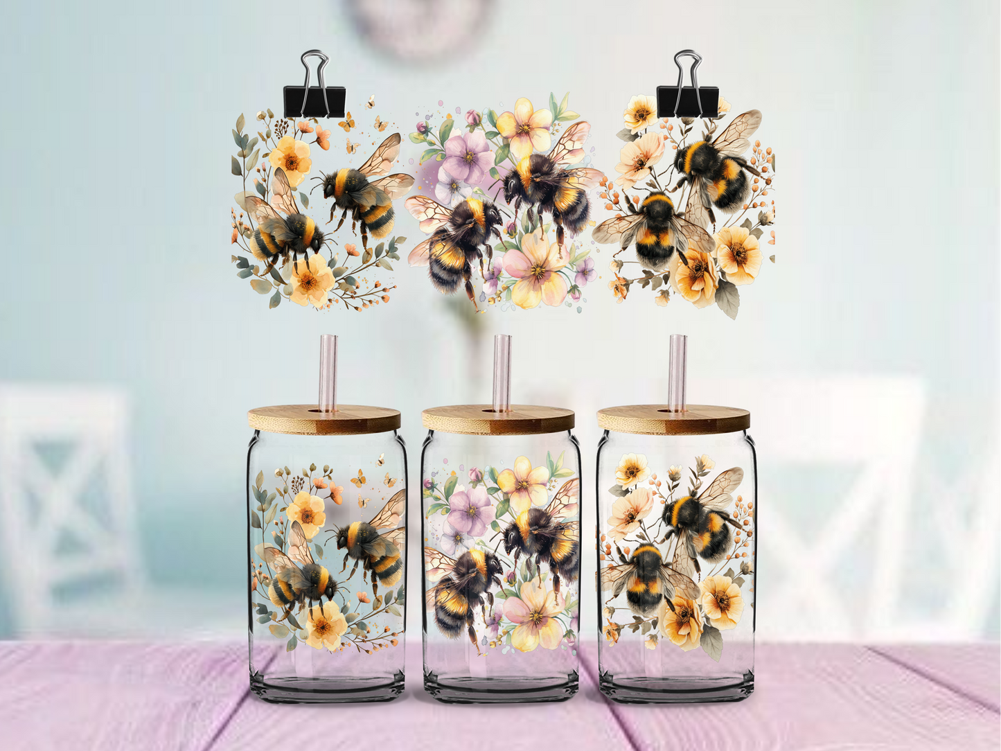 glass tumbler with bee and floral designs on a light background